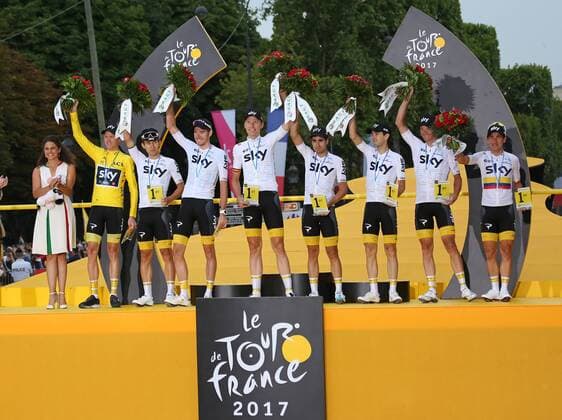 Members of Team Sky, including Chris Froome of Great Britain (yellow jersey), celebrate on the presentation podium after winning the team award at the Tour de France in Paris on July 23, 2017.  PAR20170723047 DAVIDxSILPA