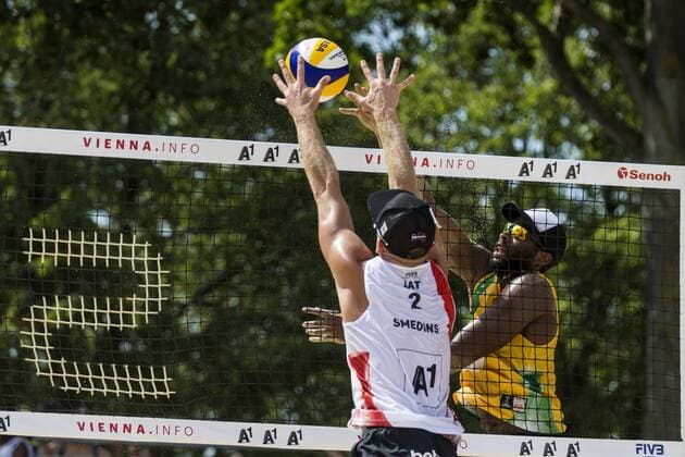 VIENNA, AUSTRIA - AUGUST 04: Evandro Goncalves Oliveira Junior of Brazil competes against Janis Smedins of Latvia during Day 8 of the FIVB Beach volleyball Beachvolleyball World Championships 2017 on August 4, 2017 in Vienna, Austria. (Photo by Michael Kunkel Hoch Zwei) Vienna Austria xHOCHxZWEIx