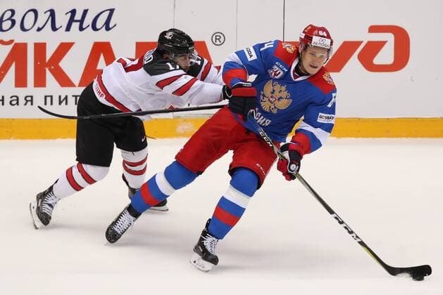 SOCHI, RUSSIA - AUGUST 7, 2017: Canada s Justin Azevedo (L) and Yegor Korshkov of the Russian Olympic team struggle for the puck in their Sochi Hockey Open 2017 match at Sochi s Bolshoi Palace of Sports. Artyom Korotayev TASS  TS05A8EA