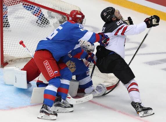 SOCHI, RUSSIA - AUGUST 7, 2017: Goaltender Igor Shestyorkin (C) of the Russian Olympic team supported by Yevgeny Ketov (L) defends against Canada s Brandon Buck in their Sochi Hockey Open 2017 match at Sochi s Bolshoi Palace of Sports. Artyom Korotayev TASS  TS05A8EC