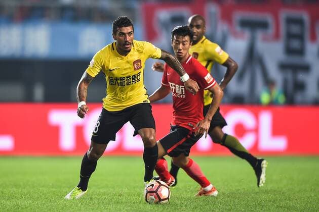Brazilian football player Paulinho, left, of Guangzhou Evergrande kicks the ball to make a pass against a player of Liaoning Whowin in their 21st round match during the 2017 Chinese Football Association Super League (CSL) in Shenyang city, northeast China s Liaoning province, 10 August 2017. Guangzhou Evergrande competes against Liaoning Whowin at 21st round of 2017 CSL  20170810_81826