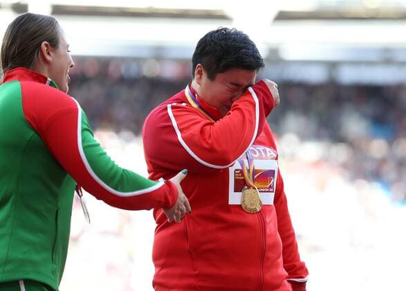 August 10th 2017, London Stadium, East London, England; IAAF World Championships, Day 7; Lijiao Gong of China, wearing the Gold Medal for womens shot put, gets emotional after the People& x2019;s Republic of China National Anthem was played during the medal ceremony xJohnxPatrickxFletcherx  ActionPlus11914320