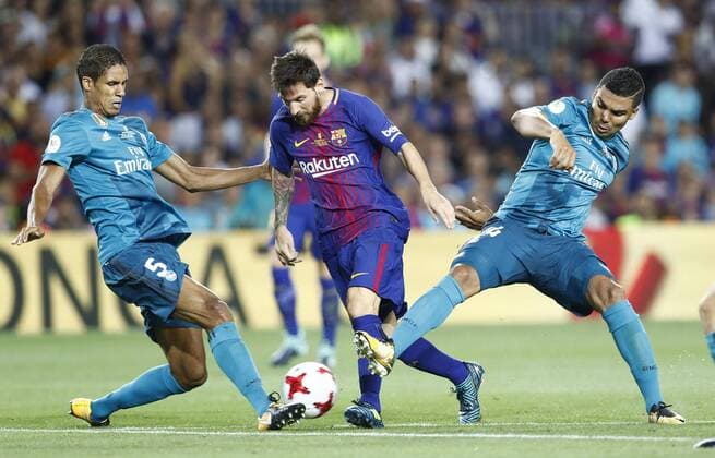 FC Barcelona Barca s Leo Messi (c) and Real Madrid s Raphael Varane (l) and Carlos Henrique Casemiro during Supercup of Spain 1st match. August 13,2017.  (2017081315)