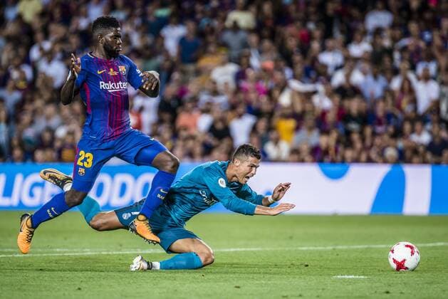 August 13, 2017 - Barcelona, Catalonia, Spain - Real Madrid forward RONALDO flies onto the ground in the penalty area followed by FC Barcelona Barca defender UMTITI in a disputed scene during the Spanish Super Cup Final 1st leg between FC Barcelona and Real Madrid at the Camp Nou stadium in Barcelona. FC Barcelona 1:3 Real Madrid - Spanish Super Cup 2017 - ZUMAo105 20170813_zap_o105_001 Copyright: xMatthiasxOesterlex