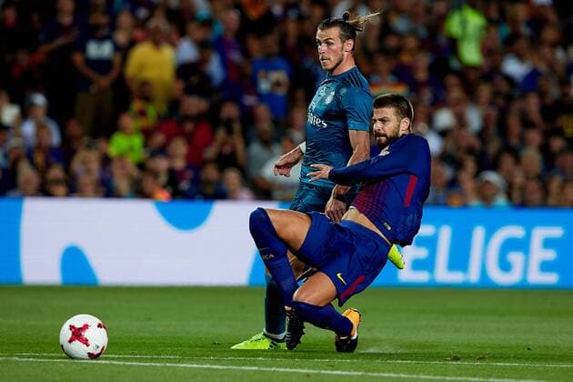 August 13th 2017, Nou Camp, Barcelona, Spain; Spanish Football Supercopa 1st Leg FC Barcelona Barca versus Real Madrid; Gerard Pique (R) of FC Barcelona competes for the ball with Gareth Bale of Real Madrid CF; xDavidxAliagax  ActionPlus11916317