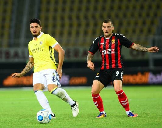 Ozan Tufan of Fenerbahce and Dejan Blazevski of Vardar Skopje during the UEFA Europa League Play off firt leg match between FK Vardar Skopje and Fenerbahce at Nacionalna Arena Filip II Makedonski Stadium in Skopje , Makedonia on August 17 , 2017. 