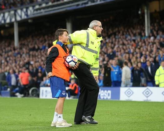 A young ball boy is protected by a steward following crowd violence during the Europa League Qualifying Play Offs 1st Leg match at Goodison Park Stadium, Liverpool. Picture date: August 17th 2017. Picture credit should read: David Klein Sportimage EDITORIAL USE ONLY. No use with unauthorised audio, video, data, fixture lists, club league logos or live services. Online in-match use limited to 120 images, no video emulation. No use in betting, games or single club league player publications.