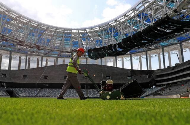 NIZHNY NOVGOROD, RUSSIA - AUGUST 26, 2017: A worker operates pitch maintenance machinery at Nizhny Novgorod Stadium, a venue for 2018 FIFA World Cup WM Weltmeisterschaft Fussball matches. Sergei Fadeichev TASS  TS05CF20