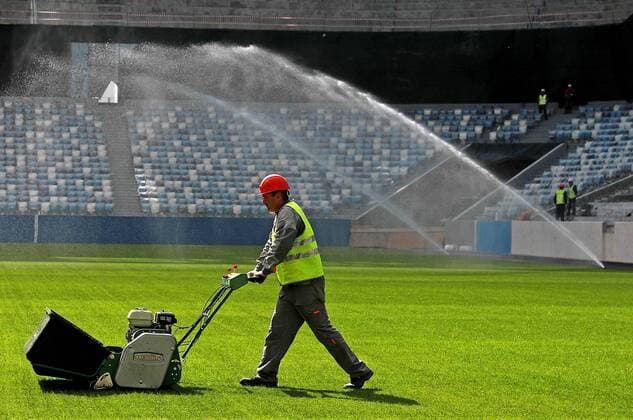 NIZHNY NOVGOROD, RUSSIA - AUGUST 26, 2017: A worker operates pitch maintenance machinery at Nizhny Novgorod Stadium, a venue for 2018 FIFA World Cup WM Weltmeisterschaft Fussball matches. Sergei Fadeichev TASS  TS05CF21