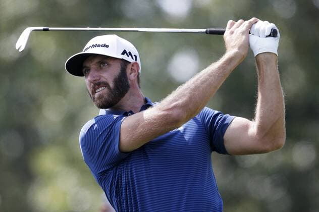 Dustin Johnson hits his tee shot on hole 2 in the final round of The Northern Trust golf championship at the Glen Oaks Club in Old Westbury, New York on August 27, 2017. Glen Oaks Club is hosting THE NORTHERN TRUST for the first time.  NYP20170827110 JOHNxANGELILLO