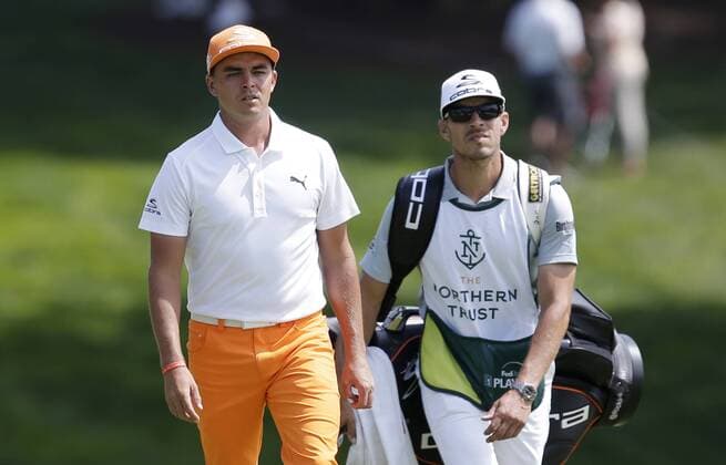 Rickie Fowler and caddie Joe Skovron walk to the 9th green in the final round of The Northern Trust golf championship at the Glen Oaks Club in Old Westbury, New York on August 27, 2017. Glen Oaks Club is hosting THE NORTHERN TRUST for the first time.  NYP20170827102 JOHNxANGELILLO