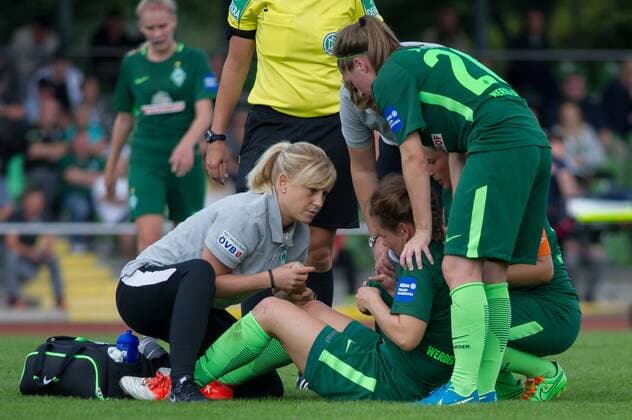 Janine Angrick (SV Werder Bremen, 8) liegt verletzt am Boden, Verletzung, Schmerzen, schmerzverzerrtes Gesicht, wird von Physiotherapeutin Laura Kersting (SV Werder Bremen) verletzt behandelt, Verletzung, Schmerzen, schmerzverzerrtes Gesicht, Fussball, Allianz Frauen-Bundesliga, SV Werder Bremen - SC Sand, xobx