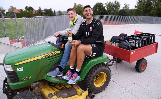 Volleyball 1 Bundesliga Season 2017 2018 Media Day Photo shooting TV Rottenburg 08 09 2017 Newcomer and Joker Idner Faustino Lima Martins right with and PR Manager Moritz Liss on a Lawn tractor Rottenburg