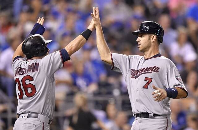 September 8, 2017 - Kansas City, MO, USA - The Minnesota Twins Robbie Grossman (36) and Joe Mauer (7) greet each other after scoring on a single by Eddie Rosario in the fourth inning against the Kansas City Royals at Kauffman Stadium in Kansas City, Mo., on Friday, Sept. 8, 2017. Minnesota at Kansas City - ZUMAm67_ 20170908_zaf_m67_064 Copyright: xJohnxSleezerx