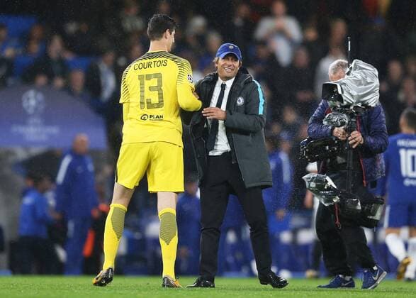 12th September 2017, Stamford Bridge, London, England; UEFA Champions League Group stage, Chelsea versus Qarabag FK; Chelsea Manager Antonio Conte hugs Goalkeeper Thibaut Courtois of Chelsea after the final whistle as the rain continues to come down  ActionPlus11929564