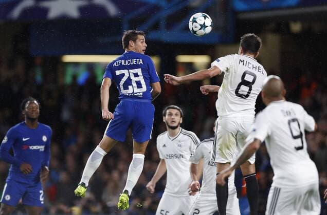 (170913) -- LONDON, Sept. 13, 2017 -- Cesar Azpilicueta (L, Above) of Chelsea heads for the ball with Michel of Qarabag FK during the UEFA Champions League Group C match between Chelsea and Qarabag FK at Stamford Bridge Stadium in London, Britain on Sept. 12, 2017. Chelsea won 6-0. ) (SP)BRITAIN-LONDON-FOOTBALL-UEFA CHAMPIONS LEAGUE-CHELSEA VS QARABAG FK HanxYan 