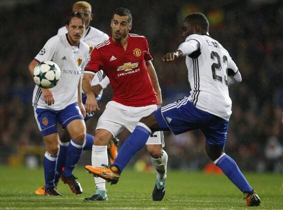 Henrikh Mkhitaryan of Manchester United ManU (C) is tackled by Luca Zuffi of Basel (L) and Eder Alvarez Balanta of Basel (R) during the Champions League Group A match at the Old Trafford Stadium, Manchester. Picture date: September 12th 2017. Picture credit should read: Andrew Yates Sportimage EDITORIAL USE ONLY. No use with unauthorised audio, video, data, fixture lists, club league logos or live services. Online in-match use limited to 120 images, no video emulation. No use in betting, games or single club league player publications.