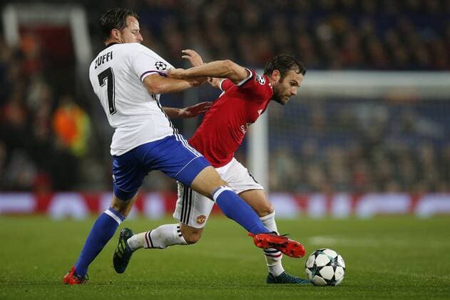 Juan Mata of Manchester United ManU (R) is tackled by Luca Zuffi of Basel during the Champions League Group A match at the Old Trafford Stadium, Manchester. Picture date: September 12th 2017. Picture credit should read: Andrew Yates Sportimage EDITORIAL USE ONLY. No use with unauthorised audio, video, data, fixture lists, club league logos or live services. Online in-match use limited to 120 images, no video emulation. No use in betting, games or single club league player publications.