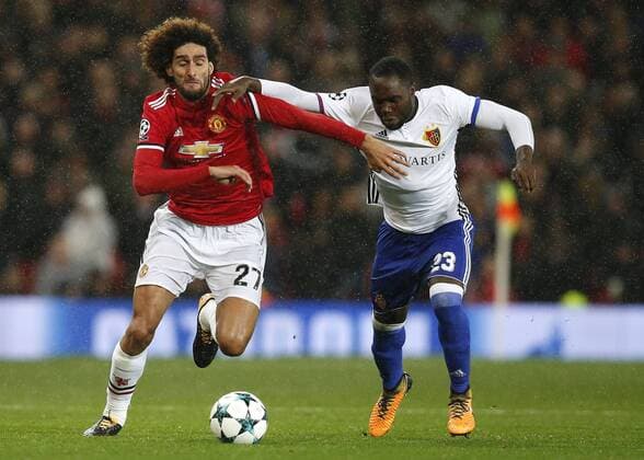 Marouane Fellaini of Manchester United ManU (L) is tackled by Eder Alvarez Balanta of Basel during the Champions League Group A match at the Old Trafford Stadium, Manchester. Picture date: September 12th 2017. Picture credit should read: Andrew Yates Sportimage EDITORIAL USE ONLY. No use with unauthorised audio, video, data, fixture lists, club league logos or live services. Online in-match use limited to 120 images, no video emulation. No use in betting, games or single club league player publications.