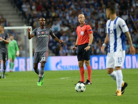 Referee Anthony Taylor and Atiba Hutchinson of Besiktas during the UEFA Champions League match between Porto and Besiktas at Estadio do Dragao Stadium in Porto , Portugal on September 13 , 2017. 