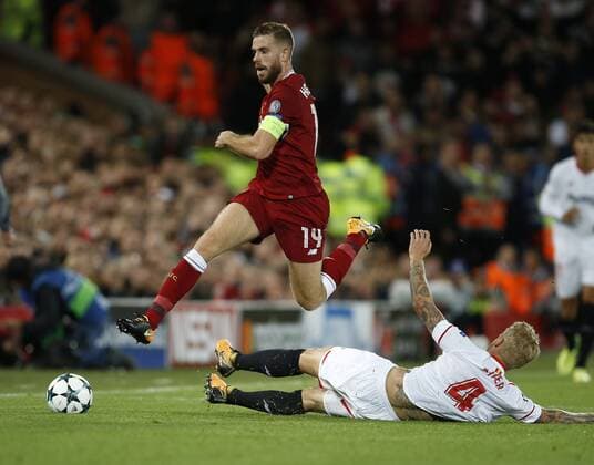 Jordan Henderson of Liverpool tackled by Simon Kjaer of Sevilla during the Champions League Group E match at the Anfield Stadium, Liverpool. Picture date 13th September 2017. Picture credit should read: Simon Bellis Sportimage EDITORIAL USE ONLY. No use with unauthorised audio, video, data, fixture lists, club league logos or live services. Online in-match use limited to 120 images, no video emulation. No use in betting, games or single club league player publications.