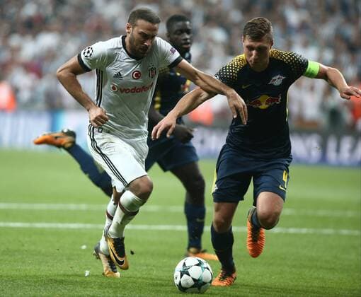 Cenk Tosun of Besiktas and Willi Orban 4 of RB Leipzig during the UEFA Champions League Group G match between Besiktas and RB Leipzig at Vodafone Park in Istanbul , Turkey on September 26 , 2017 . 