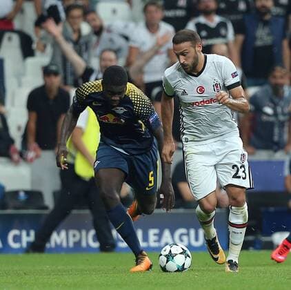 Cenk Tosun of Besiktas and Dayot Upamecano of RB Leipzig during the UEFA Champions League Group G match between Besiktas and RB Leipzig at Vodafone Park in Istanbul , Turkey on September 26 , 2017 . 