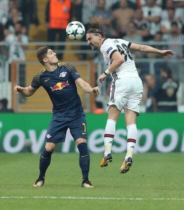 Caner Erkin of Besiktas and Marcel Sabitzer of RB Leipzig during the UEFA Champions League Group G match between Besiktas and RB Leipzig at Vodafone Park in Istanbul , Turkey on September 26 , 2017 . 
