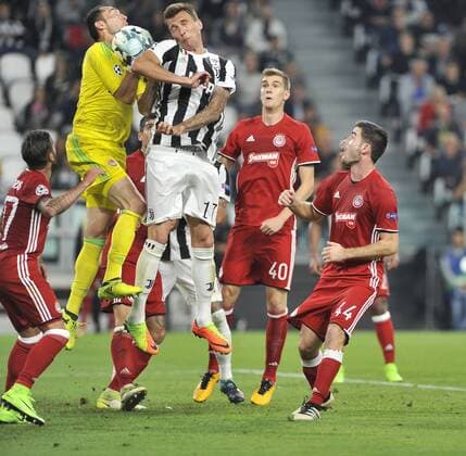 Juventus v Olympiacos F.C. UEFA Champions League Mario Mandzukic of Juventus competes with goal keeper Silvio Proto of Olympiacos F.C. during the UEFA Champions League match at Juventus Stadium, Turin Content Not Available For UK Newspapers Copyright: xStefanoxGnechx FIL-10734-0007