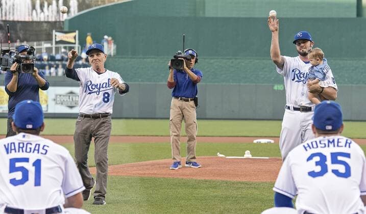 September 30, 2017 - Kansas City, MO, USA - The Kansas City Royals Mike Moustakas holds his daughter, Mila, while throwing out the ceremonial first pitch next to his father, Mike Sr., after being honored in a pregame ceremony for his club record for home runs before a game against the Arizona Diamondbacks at Kauffman Stadium in Kansas City, Mo., on Saturday, Sept, 30, 2017. Arizona at Kansas City - ZUMAm67_ 20170930_zaf_m67_081 Copyright: xJohnxSleezerx