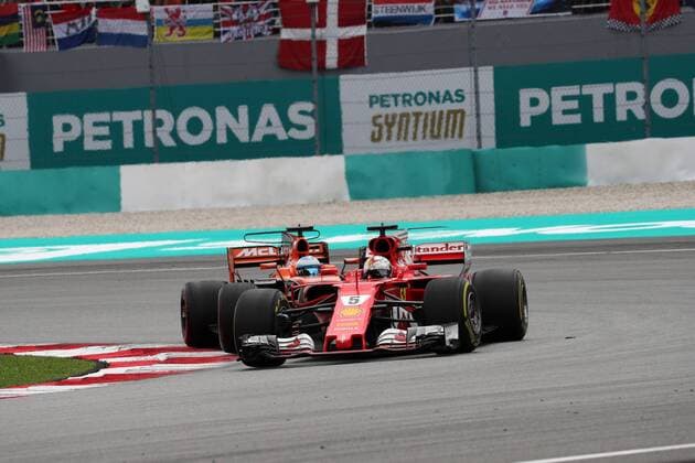 01.10.2017 - Race, Sebastian Vettel (GER) Scuderia Ferrari SF70H and Fernando Alonso (ESP) McLaren MCL32 Malaysian Grand Prix, Sepang 28 September - 1 October 2017 01.10.2017 - Race, Sebastian Vettel (GER) Scuderia Ferrari SF70H and Fernando Alonso (ESP) McLaren MCL32 