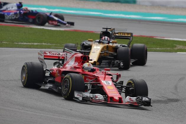01.10.2017 - Race, Sebastian Vettel (GER) Scuderia Ferrari SF70H and Nico Hulkenberg (GER) Renault F1 Team RS17 Malaysian Grand Prix, Sepang 28 September - 1 October 2017 01.10.2017 - Race, Sebastian Vettel (GER) Scuderia Ferrari SF70H and Nico Hulkenberg (GER) Renault Sport F1 Team RS17 