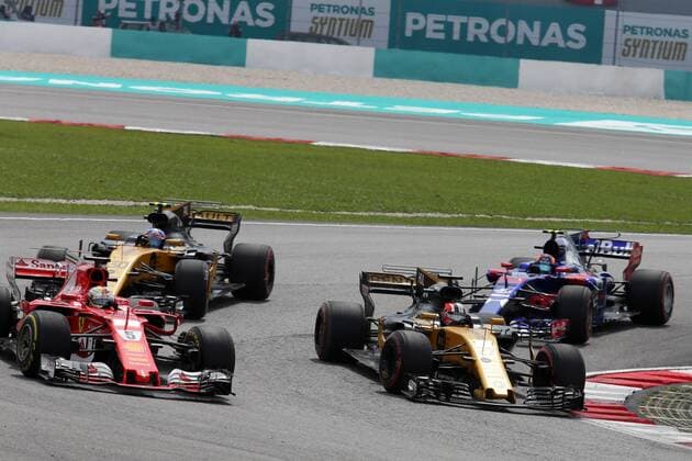 01.10.2017 - Race, Sebastian Vettel (GER) Scuderia Ferrari SF70H and Nico Hulkenberg (GER) Renault F1 Team RS17 Malaysian Grand Prix, Sepang 28 September - 1 October 2017 01.10.2017 - Race, Sebastian Vettel (GER) Scuderia Ferrari SF70H and Nico Hulkenberg (GER) Renault Sport F1 Team RS17 