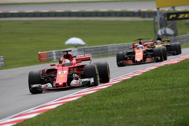 01.10.2017 - Race, Sebastian Vettel (GER) Scuderia Ferrari SF70H leads Fernando Alonso (ESP) McLaren MCL32 Malaysian Grand Prix, Sepang 28 September - 1 October 2017 01.10.2017 - Race, Sebastian Vettel (GER) Scuderia Ferrari SF70H leads Fernando Alonso (ESP) McLaren MCL32 