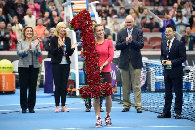 (171007) -- BEIJING, Oct. 7, 2017 -- Simona Halep (Front) of Romania celebrates after being presented with a bouquet in the shape of the number 1 , after surging to world number one by winning her women s singles semifinal match against Jelena Ostapenko of Latvia at the China Open tennis tournament in Beijing on Oct. 7, 2017. Simona Halep won 2-0 and advanced to the final. )(wll) (SP)CHINA-BEIJING-TENNIS-CHINA OPEN(CN) JuxHuanzong 