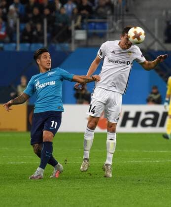 Russia. St. Petersburg. October 19, 2017. The players of Zenith Mathias Kranevitter; Branislav Ivanovic and Rosenborg Anders Trondsen (left to right) in the group stage match of the UEFA Europa League between Zenit (Russia, St. Petersburg) and Rosenborg (Norway, Trondheim).