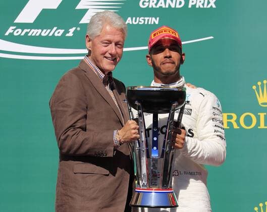 AUSTIN, TX - OCTOBER 22: Former US President Bill Clinton and Lewis Hamilton with the winners trophy for the United States Grand Prix on October 22, 2017, at the Circuit of The Americas in Austin, TX. (Photo by David John Griffin Icon Sportswire) AUTO: OCT 22 F1 - United States Grand Prix Icon9531710220573 EDITORIAL USE ONLY