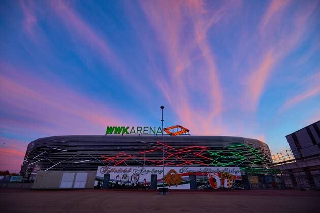 WWK Arena Augsburg illuminated facade in club colors red green white north side