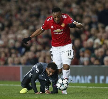 Douglas of SL Benfica tumbles at the feet of Anthony Martial of Manchester United ManU during the Champions League Group A match at the Old Trafford Stadium, Manchester. Picture date: October 31st 2017. Picture credit should read: Andrew Yates Sportimage EDITORIAL USE ONLY. No use with unauthorised audio, video, data, fixture lists, club league logos or live services. Online in-match use limited to 120 images, no video emulation. No use in betting, games or single club league player publications.