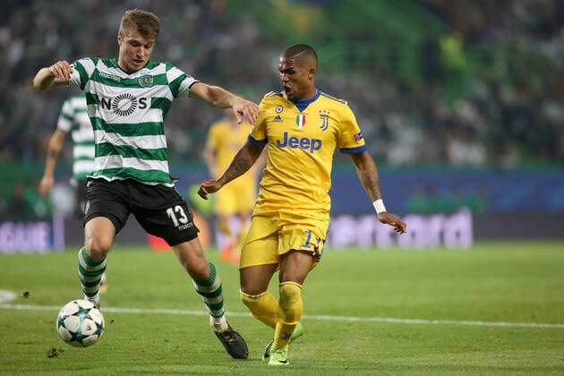 October 31, 2017 - Lisbon, Portugal - Sporting s defender Stefan Ristovsk from Macedonia (L) vies with Juventus Brazilian forward Douglas Costa during the UEFA Champions League football match Sporting CP vs Juventus at the Alvalade stadium in Lisbon, Portugal on October 31, 2017. Sporting CP v Juventus - UEFA Champions League  - ZUMAn230 20171031_zaa_n230_492 Copyright: xPedroxFiuzax