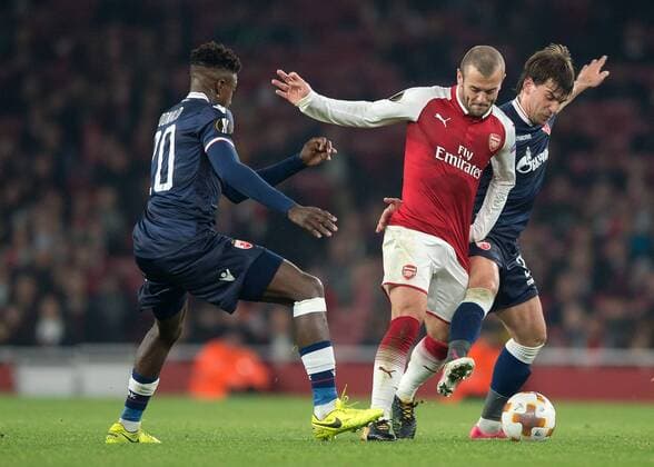 Jack Wilshere of Arsenal battles with Filip Stojkovic of Red Star Belgrade and Mitchell Donald of Red Star Belgrade during the UEFA Europa League group H match between Arsenal and Red Star Belgrade at the Emirates Stadium, London, England on 2 November 2017. Copyright: xVincexMignottx 17500024