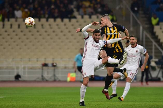Italy: AEK versus Milan Ognjen Vranjes of AEK (no. 4)attempts to score under the pressure of Mateo Mussachio (no. 22) Athens Attiki Greece OAKA Spiros Louis  DimitriosxKarvountzisx xPacificxPress