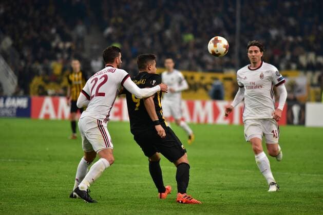 Italy: AEK versus Milan Giorgos Giakoumakis (no 9) of AEK tries to control the ball under the pressure of Mateo Musacchio (no 22) and of Riccardo Montolivo (no 18) of Milan. Athens Attiki Greece OAKA Spiros Louis  DimitriosxKarvountzisx xPacificxPress