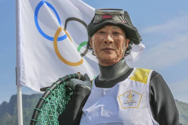 November 3, 2017 - Sungsan, Jeju, South Korea - Nov 3, 2017 - Jeju, South Korea-Female divers, or haenyeo in Korean, celebrate as they hold the Olympic flame for the 2018 PyeongChang Games as part of the torch relay on the southern resort island of Jeju on Nov. 3, 2017. 2018 Pyeongchang Olympic Torch Run on Jeju - ZUMAr168 20171103_zap_r168_015 Copyright: xRyuxSeung-Ilx