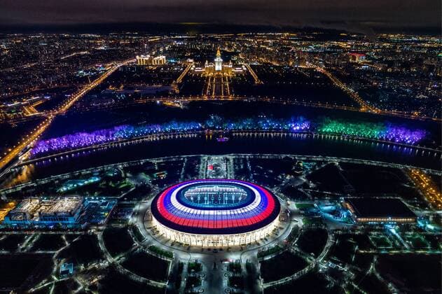 MOSCOW, RUSSIA - NOVEMBER 4, 2017: The roof of Moscow s Luzhniki Stadium is lit with the white, blue, and red colours of the Russian national flag during a concert marking Russia s Day of National Unity with the Lomonosov Moscow State University main building in the background. Dmitry Serebryakov TASS  80746009st