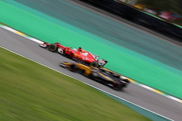 11.11.2017 - Qualifying, Sebastian Vettel (GER) Scuderia Ferrari SF70H and Carlos Sainz Jr (ESP) Renault F1 Team RS17 Brazilian Grand Prix, Sao Paulo, Interlagos 9 - 12 November 2017 11.11.2017 - Qualifying, Sebastian Vettel (GER) Scuderia Ferrari SF70H and Carlos Sainz Jr (ESP) Renault Sport F1 Team RS17 