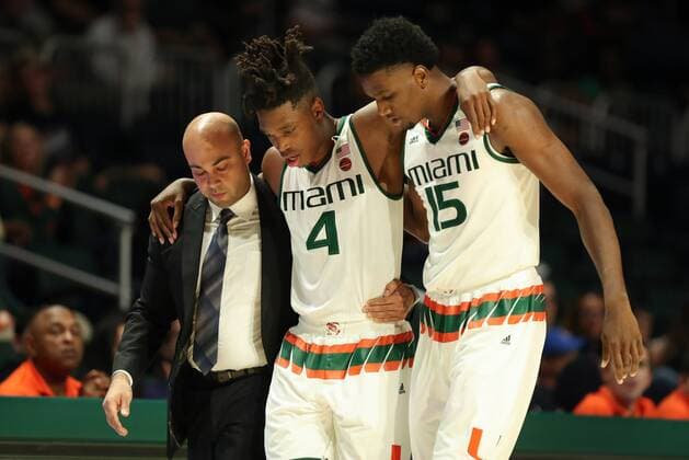 November 16, 2017: Miami Hurricanes guard Lonnie Walker IV (4) is helped off the court by Miami Hurricanes athletic trainer Javier Jimezez, left, and center Ebuka Izundu (15), right, after an injury during the first half of the NCAA College League USA men s basketball game between the Florida A&M Rattlers and the University of Miami Hurricanes at the Watsco Center in Coral Gables, Florida. CSM NCAA Basketball 2017: Florida A&M vs Miami NOV 16 - ZUMAc04_ 20171116_zaf_c04_060 Copyright: xMarioxHoubenx