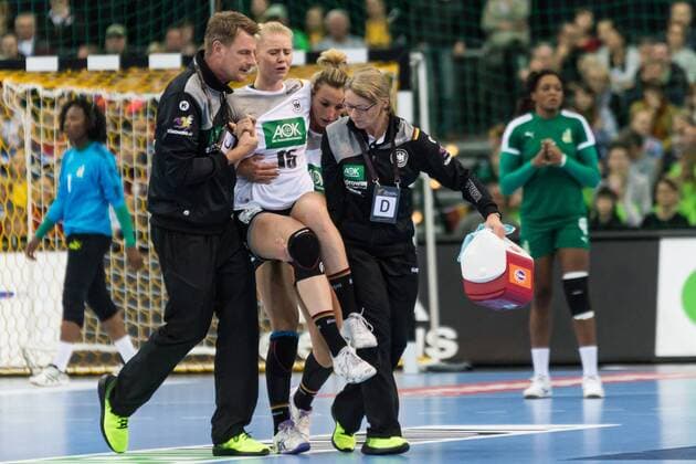Kim Naidzinavicius GER 15 already has to be carried off injured in the 3 minutes Handball Womens World Cup Germany GER CMR Cameroon xprx