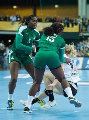 Kim Naidzinavicius 15 GER injured in this three-way fight with Yvette Yuoh 5 CMR and Anne Michelle Essam 15 CMR and goes to ground preliminary group match Germany Cameroon in Leipzig on 01 12 2017 Handball 23 Womens Handball World Cup Germany 2017