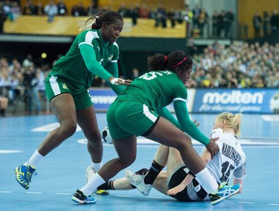 Kim Naidzinavicius 15 GER injured in this three-way fight with Yvette Yuoh 5 CMR and Anne Michelle Essam 15 CMR and goes to ground preliminary group match Germany Cameroon in Leipzig on 01 12 2017 Handball 23 Womens Handball World Cup Germany 2017
